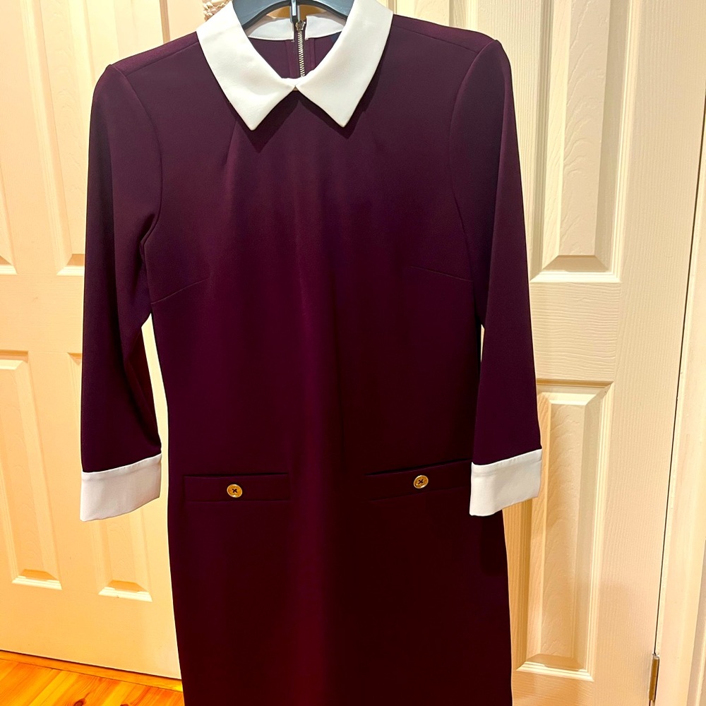 This never worn dress is Eggplant in color with a 3/4 Sleeve